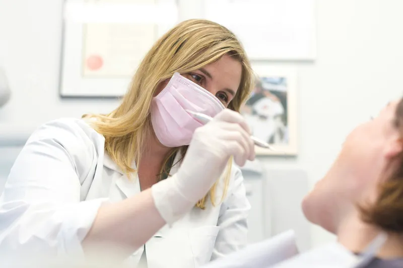 Dentist providing treatment to a patient in a modern clinic